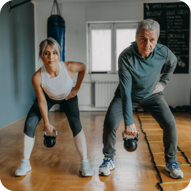 Two adults a man and a woman lifting weights with their right hand.